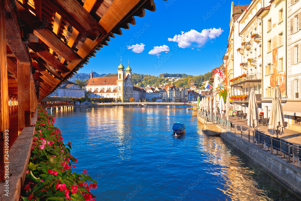 Kapellbrucke historic wooden bridge in Luzern and waterfront landmarks dawn view