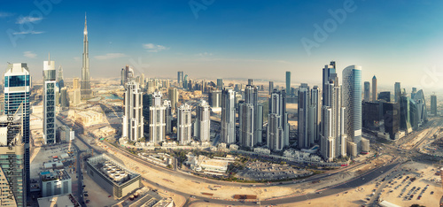 Aerial panorama view on downtown Dubai, UAE. Skyscrapers of the business bay on a summer day.