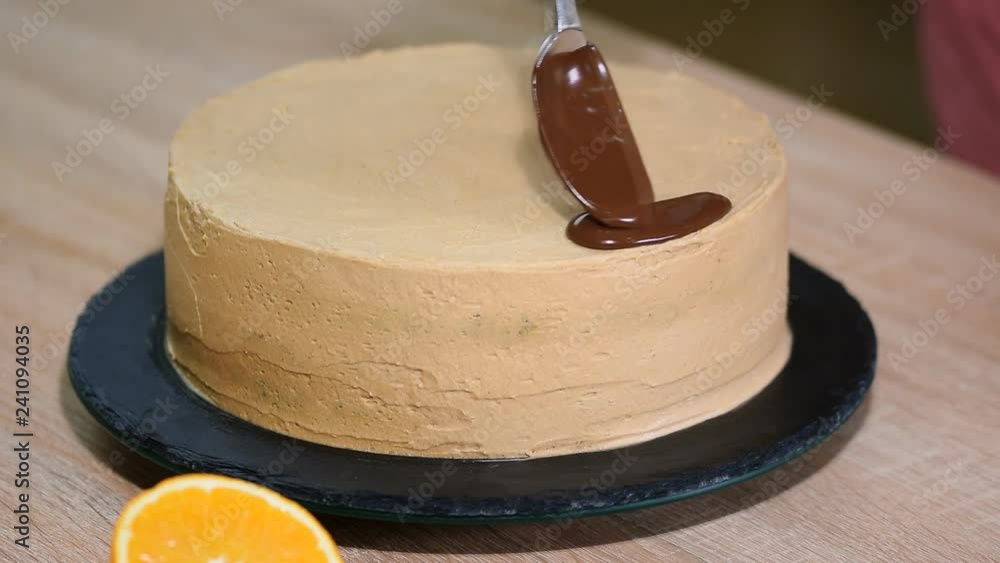 Chocolate icing on the cake. Modern Cake. Confectioner decorate a cake. Chocolate icing on the cake. Modern Cake. Confectioner decorate a cake.
