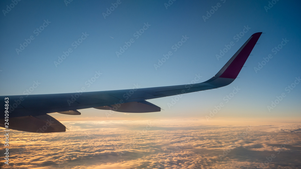 Plane wing on the sky with sunset and clouds. View from the airlane window. Plane wing on the sky with sunset and clouds. View from the airlane window.