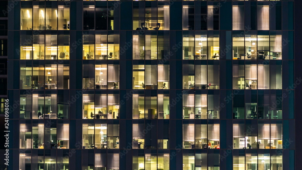 window of the multi-storey building of glass and steel lighting and people within timelapse - obrazy, fototapety, plakaty 