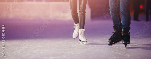 Εκτύπωση καμβά Closeup of winter skates on transparent ice rink night