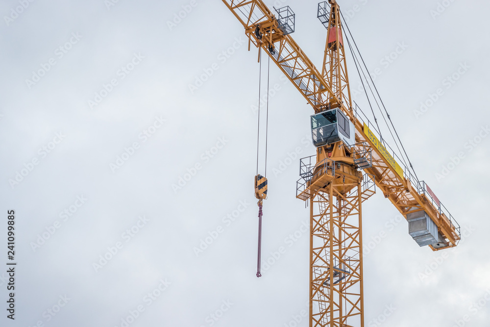 yellow construction crane against blue sky yellow construction crane against blue sky
