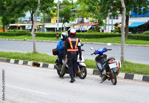 Traffic police stopping and check motorcycle / traffic policeman on the streets and motorcycle rider