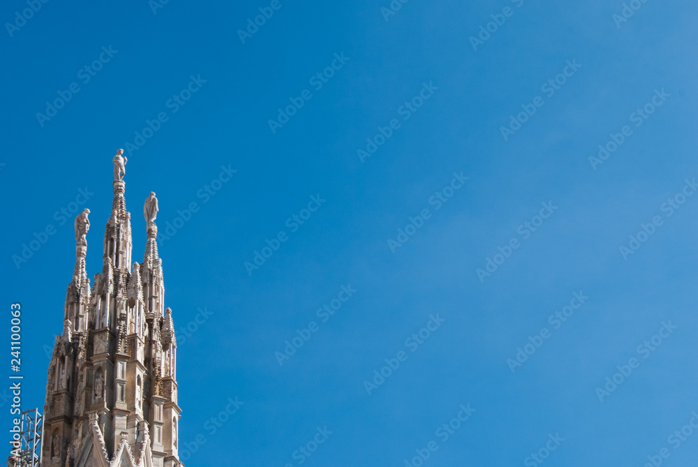 Detail of one white spire of the main Cathedral of Milan