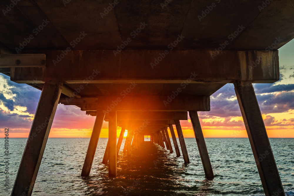 Sunset view through Glenelg jetty pylons