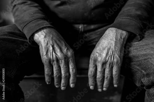 Old, tired , resting caucasian man hands close up shot, conceptual aging image for background in black and white.