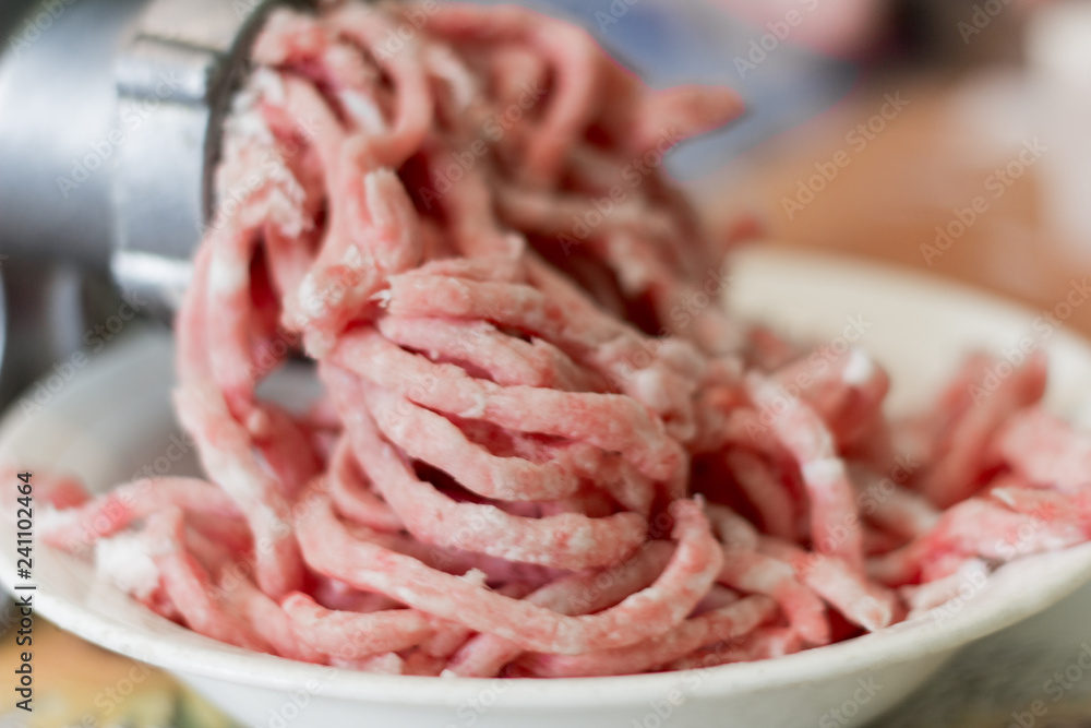 minced meat twisted on a meat grinder, selective focus minced meat twisted on a meat grinder, selective focus