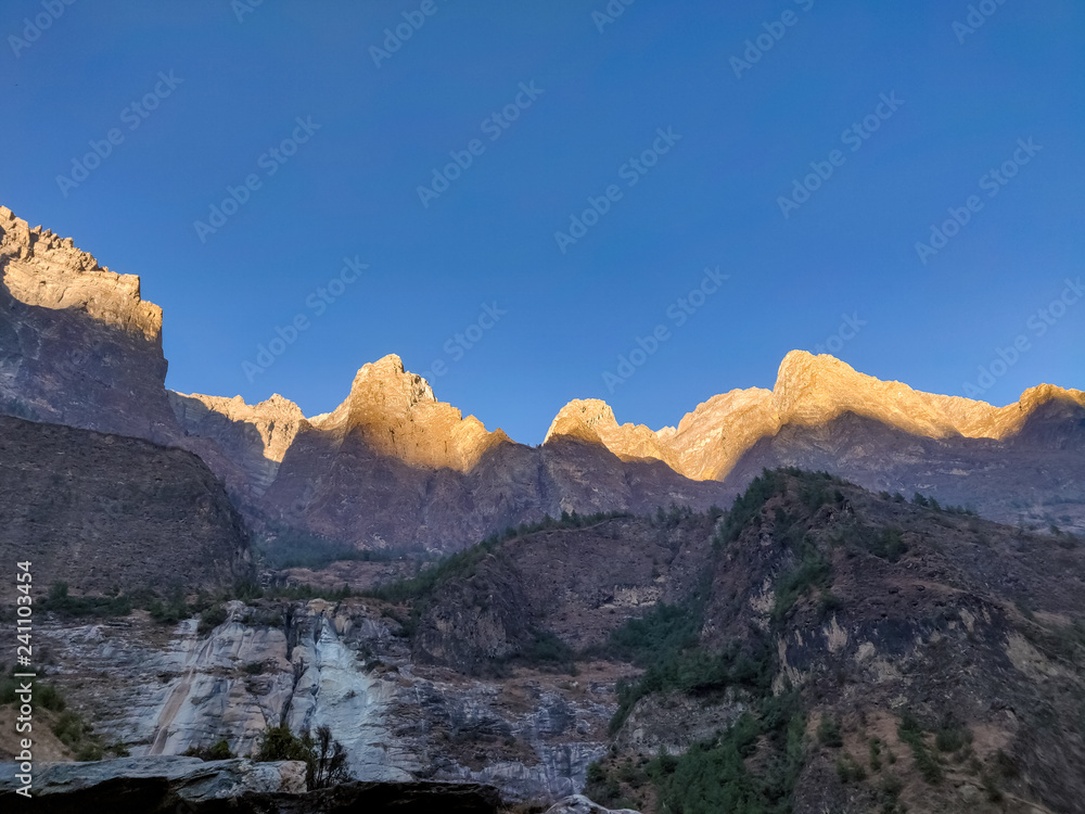 Sun rays slowing covering hilly region of  remote Nepal
