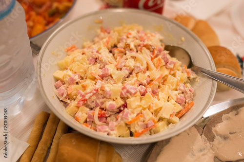 horizontal image with close detail of mixed salad with mayonnaise, cheese, ham, carrots, peppers, call capricciosa
