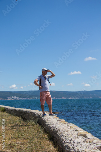 Tourist on a walk. Young boy on a walk in Nessebar. View of Nessebar. Bulgaria.