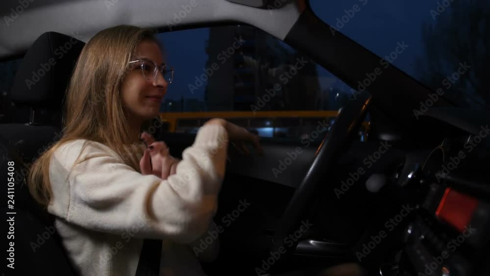 Cheerful girl rides the night city, sings and dances 4K Slow Mo