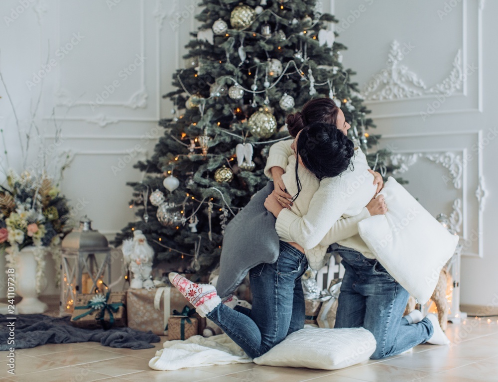 Naklejka premium Portrait of two beautiful young girls is in Christmas sceneries