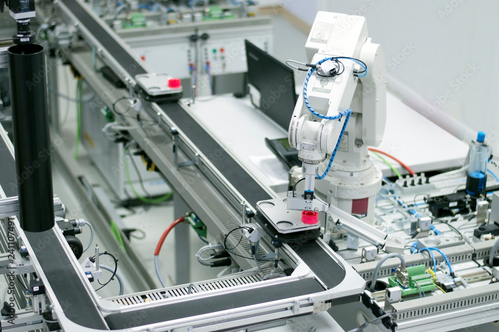 Gripper picks up the product from automated car which is on the manufacturing line in a smart factory. Industry 4.0 concept; artificial intelligence in manufacturing. Gripper picks up the product from automated car which is on the manufacturing line in a smart factory. Industry 4.0 concept; artificial intelligence in manufacturing.