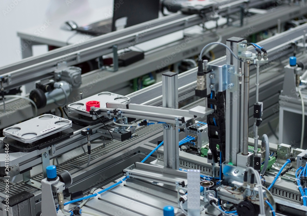 Gripper picks up the product from automated car which is on the manufacturing line in a smart factory. Industry 4.0 concept; artificial intelligence in manufacturing. Gripper picks up the product from automated car which is on the manufacturing line in a smart factory. Industry 4.0 concept; artificial intelligence in manufacturing.