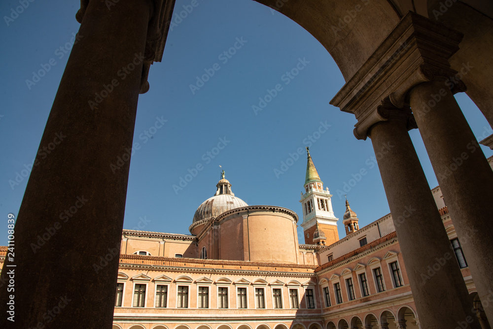 Venice, Italy, Church of San Giorgio on the island of San Giorgio Maggiore. Detail of the bell tower and dome, seen from the cloister of the Cini foundation.