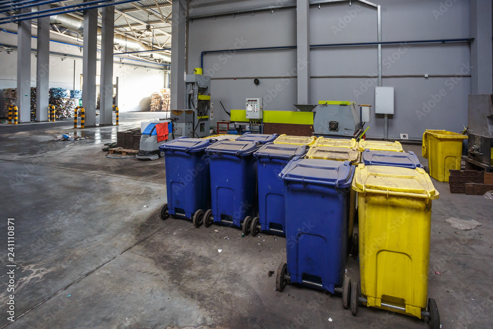 Containers with used bottles and plastic bales of rubbish at waste treatment processing plant. Recycling separatee and storage of garbage for further disposal, trash sorting. Containers with used bottles and plastic bales of rubbish at waste treatment processing plant. Recycling separatee and storage of garbage for further disposal, trash sorting.