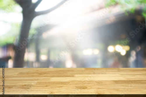 Empty brown wooden table and blur background of abstract of restaurant lights  can be used for montage or display your products.