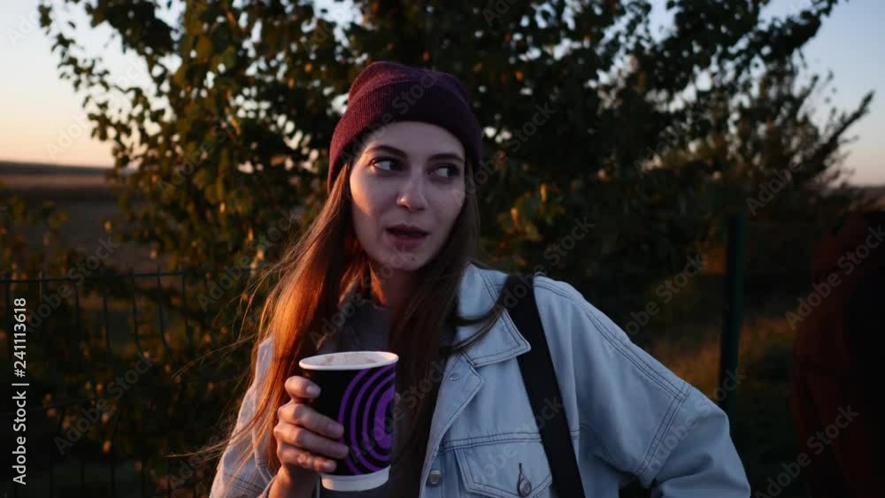 Young woman with coffee in autumn countryside
Young woman with coffee in autumn countryside