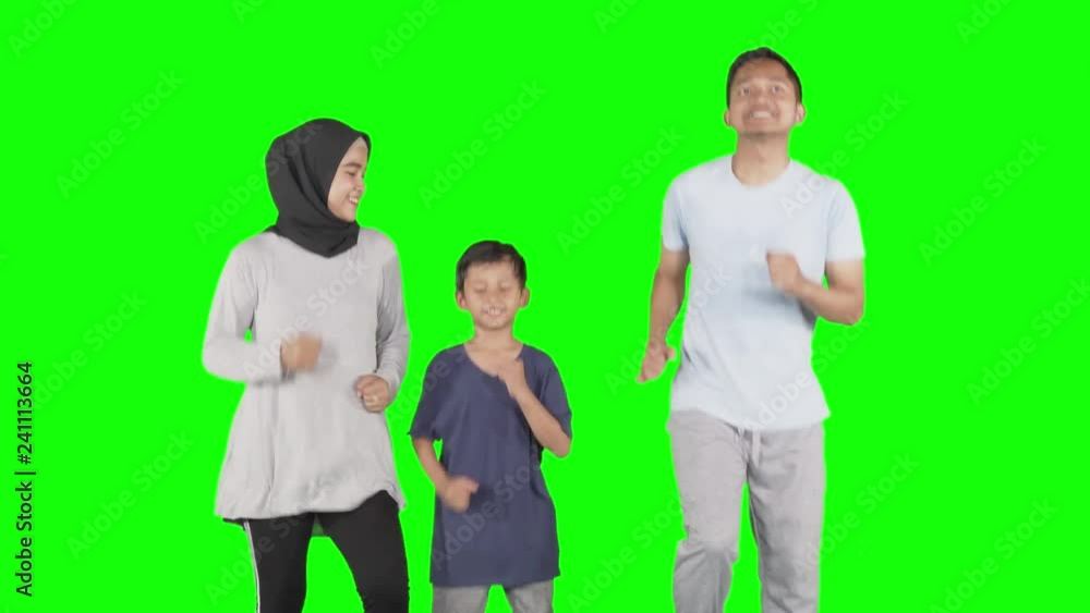 Happy family doing workout together by running in place at studio. Shot in 4k resolution with green screen background Happy family doing workout together by running in place at studio. Shot in 4k resolution with green screen background