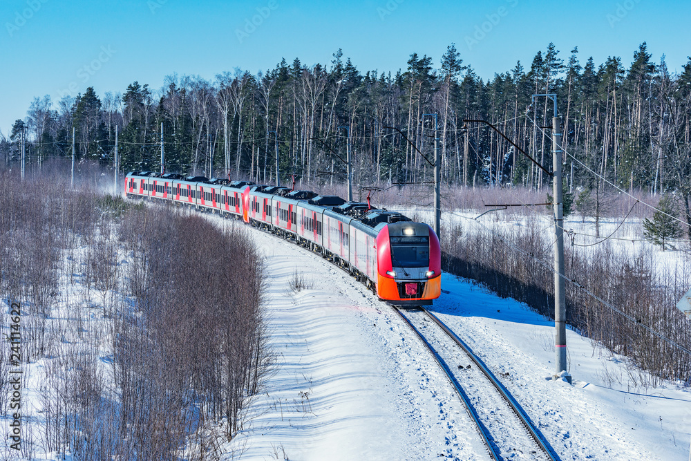Obraz premium Modern high-speed train approaches to the station at winter morning time.