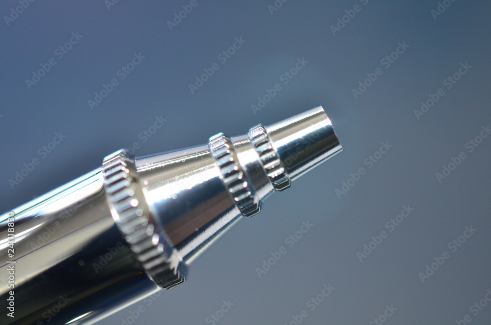 Airbrush tip detail. Needle tip of an airbrush. Approximate view of technical detail.