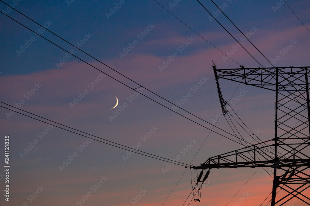 Electrical lines under a night sky with moon