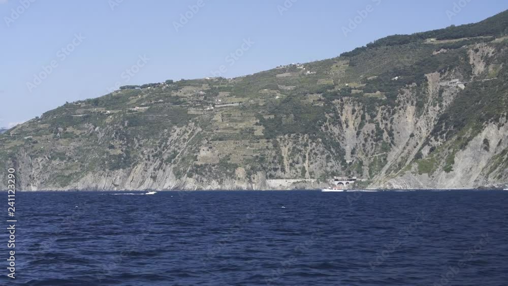 Ship sailing close to shore, Tall white sand mountains in the background. Sunny day Ship sailing close to shore, Tall white sand mountains in the background. Sunny day