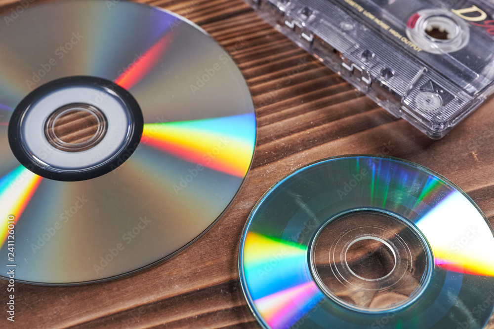 Old tape and disk recording on a wooden table Old tape and disk recording on a wooden table
