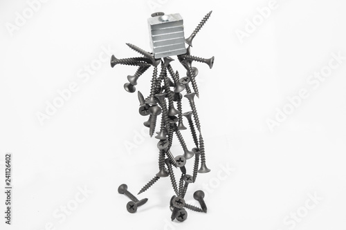 Abstract figurine of black self-tapping screws hanging on the magnet
