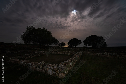 Night landscape with Roman ruins. Ancient Roman villa of Los Terminos in Monroy. Extremadura. Spain. photo