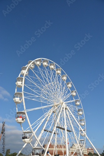 White observation wheel on blue sky