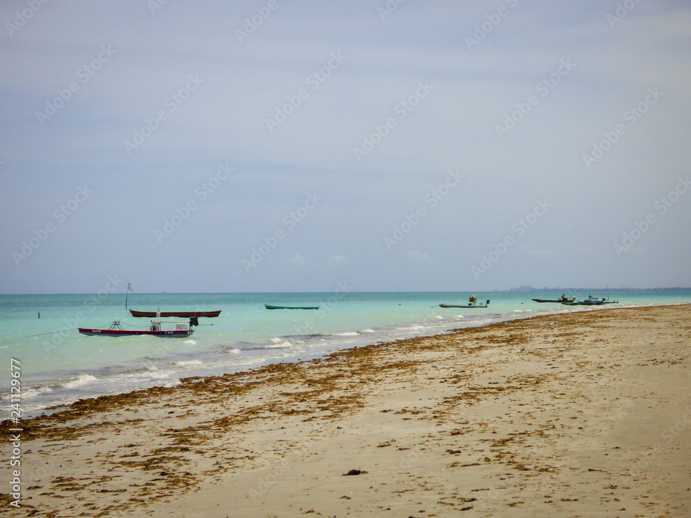Ilha de Itamaraca, Brazil - Circa December 2018: Boats in the ocean at Pilar Beach on Itamaraca Island (Pernambuco state, Brazil) Ilha de Itamaraca, Brazil - Circa December 2018: Boats in the ocean at Pilar Beach on Itamaraca Island (Pernambuco state, Brazil)