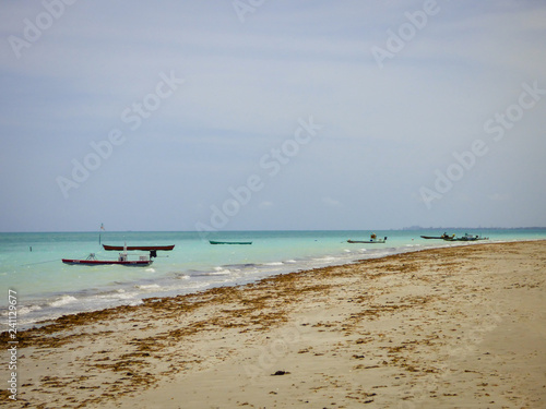 Ilha de Itamaraca, Brazil - Circa December 2018: Boats in the ocean at Pilar Beach on Itamaraca Island (Pernambuco state, Brazil) photo