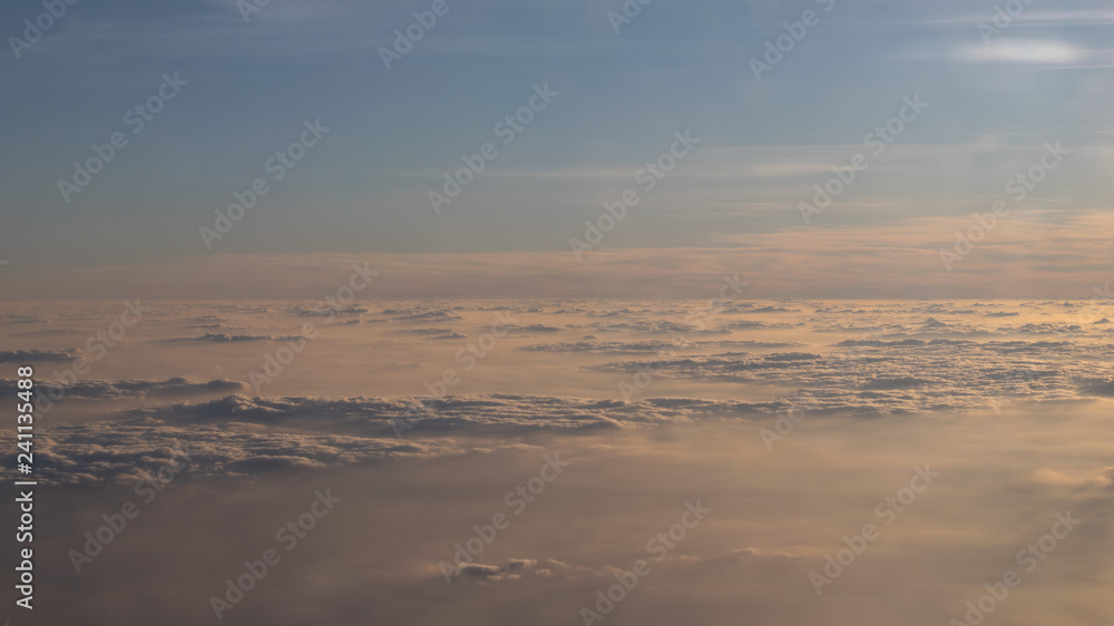 Image of Sunrise above the clouds from airplane window, India