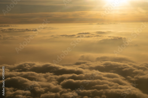 Image of Sunrise above the clouds from airplane window, India