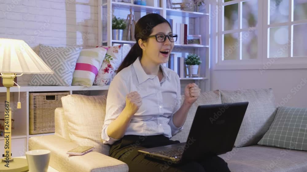 slow motion asian businesswoman looking at work on laptop computer with satisfaction and stretching arms in the air staying up late in midnight hard working. young office lady at home cheerful smile slow motion asian businesswoman looking at work on laptop computer with satisfaction and stretching arms in the air staying up late in midnight hard working. young office lady at home cheerful smile