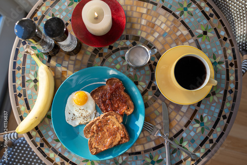 Breakfast meal with coffee, banana, beach plum jelly toast, and egg