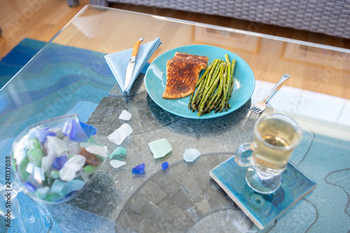 Keto lunch or dinner meal with seasoned cooked salmon, asparagus stalks and a carb-free drink