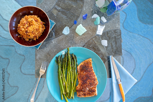 Healthy lunch or dinner meal with seasoned cooked salmon, asparagus stalks and Mexican rice