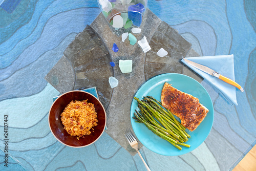Healthy lunch or dinner meal with seasoned cooked salmon, asparagus stalks and Mexican rice
