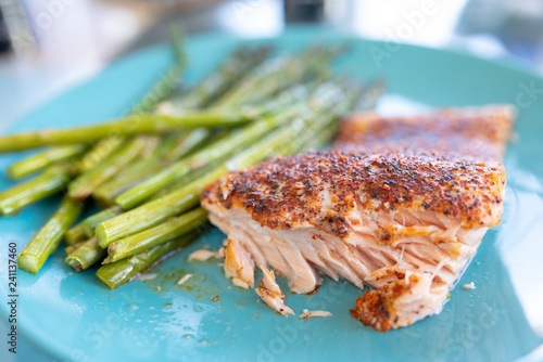 Healthy lunch or dinner meal with seasoned cooked salmon, asparagus stalks