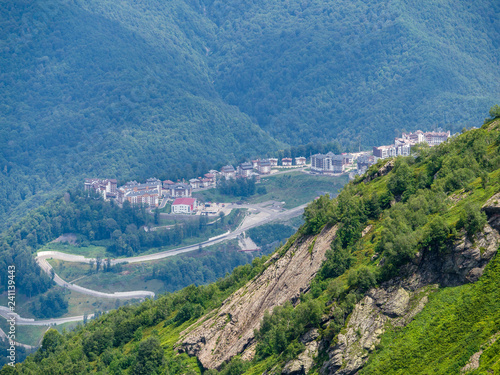 Residential homes in Green Valley  surrounded by high mountains. Rosa Khutor ski resort  Krasnaya Polyana  Sochi  Russia.