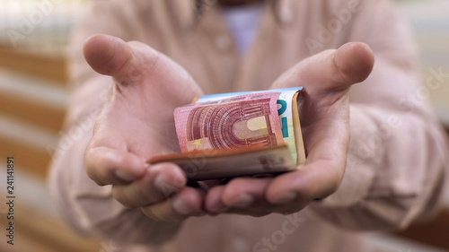 Euro banknotes in old male hands, pension savings, retirement poverty, bankrupt