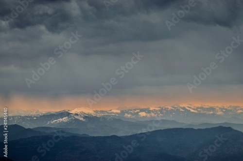 beautiful sky with clouds over snowy mountains