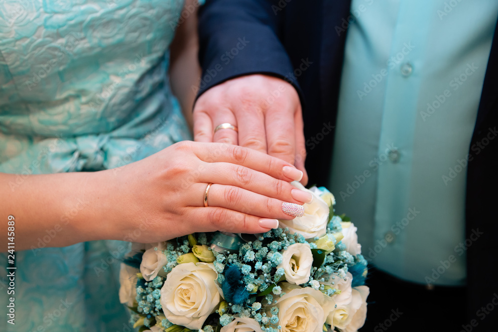 Bride and groom hands with gold wedding rings Bride and groom hands with gold wedding rings