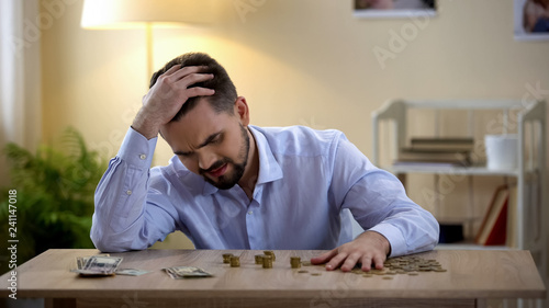 Desperate unemployed man angry after counting savings, inflation, low-paid job