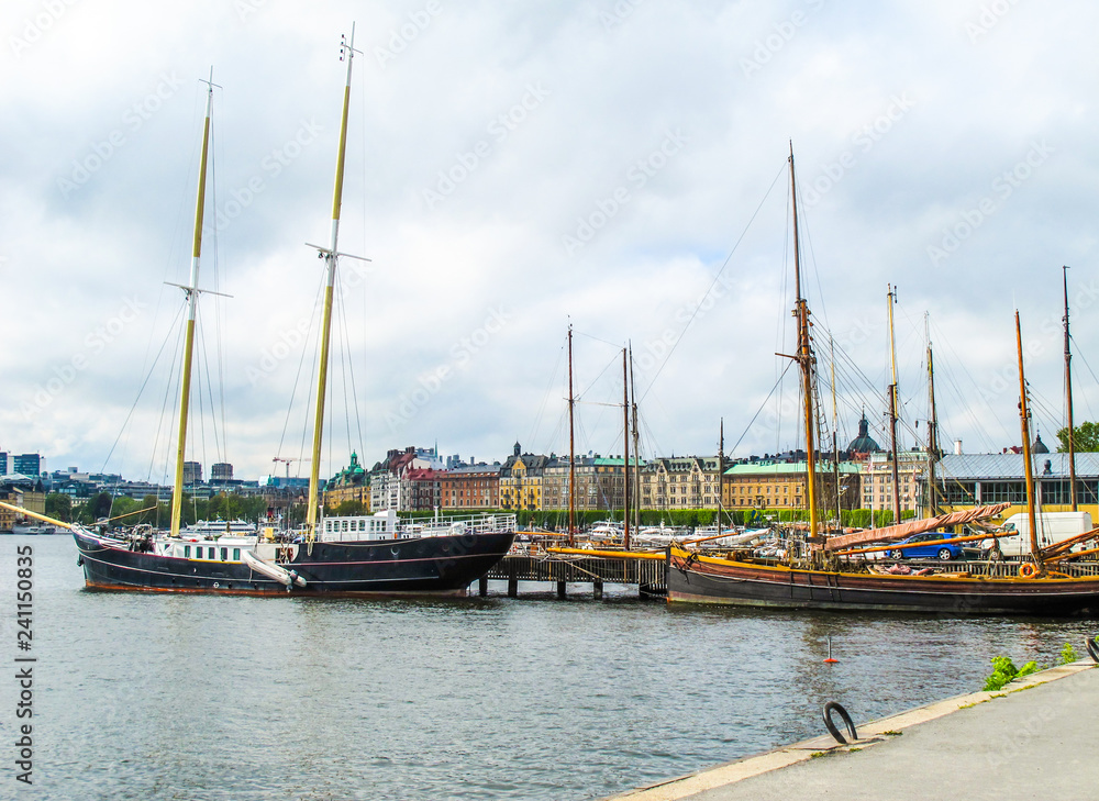 Sailboats and boats in the harbor on the background of the beautiful buildings of Stockholm Sweden