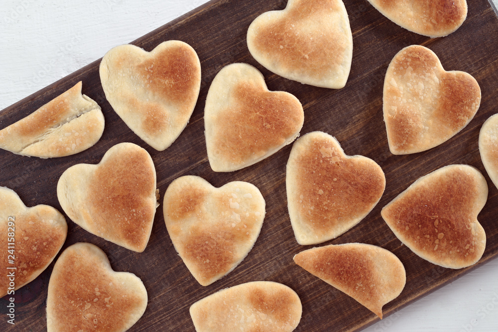 hearts of baked dough on white wood hearts of baked dough on white wood