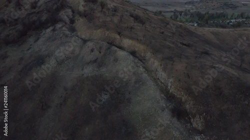 Aerial Drone Footage Slow Pan Up Over Burned Hills at Sunset Neighborhood photo